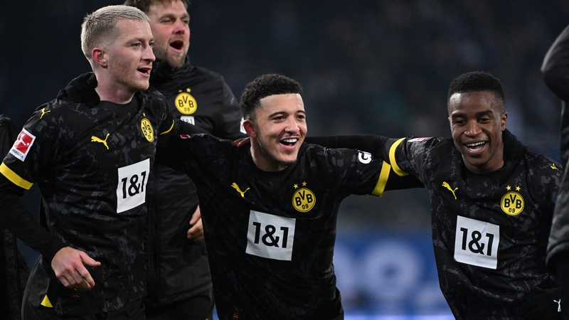 Jadon Sancho (centre) celebrates Borussia Dortmund's victory with team-mates Marco Reus (left) and Youssoufa Moukoko (right)