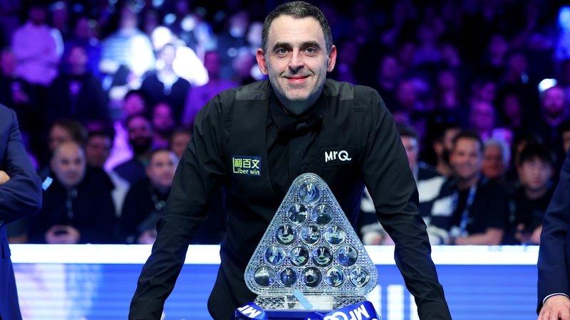 Ronnie O'Sullivan poses with the Paul Hunter trophy after winning another Masters title