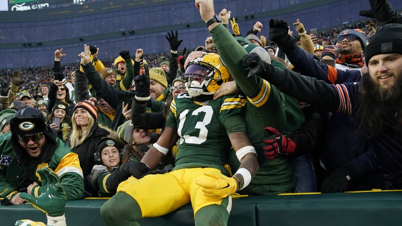 Dontayvion Wicks of the Green Bay Packers celebrates after a touchdown with fans