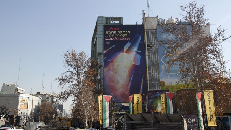 A large billboard depicting an Iranian missile hangs on the side of a building in Tehran