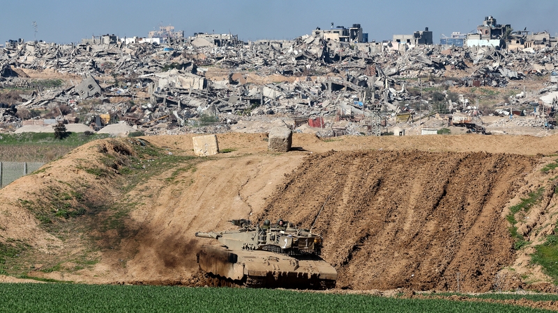An Israeli tank positioned behind a sand wall in southern Israel along the border with the Gaza