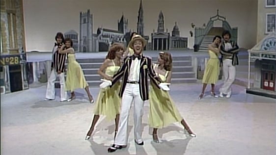 Irish actor and singer Billy Boyle leads the singing and dancing in a performance of three much lov…