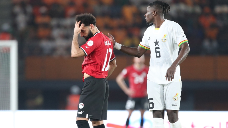 Mo Salah is comforted by Mohammed Salisu of Ghana after being forced off with an injury