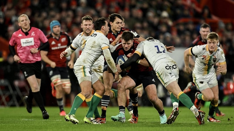 Munster's Alex Nankivell is tackled by Alex Mitchell and Rory Hutchinson of Northampton Saints