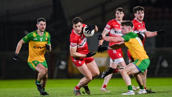 Shane McGuigan of Derry in action against Odhran Doherty of Donegal