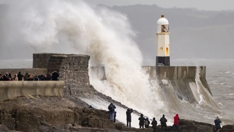 Waves crash against the harbour wall in Porthcawl, Wales