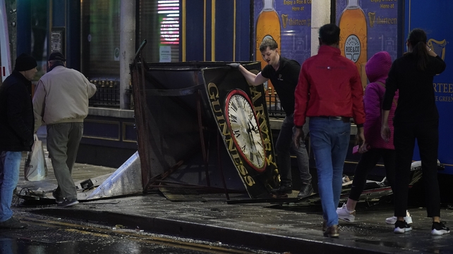 A clock tower falls to the ground in Eyre Square, Galway