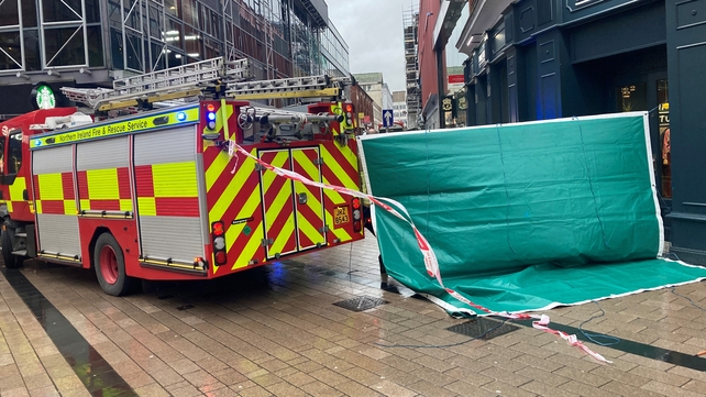 Emergency services (and below) at the scene where scaffolding was dislodged in Belfast city centre
