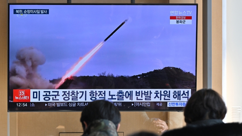 People in Seoul watch a news broadcast with file footage of a North Korean missile test