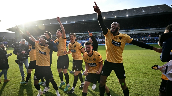 The Maidstone players celebrate with the travelling support after the game