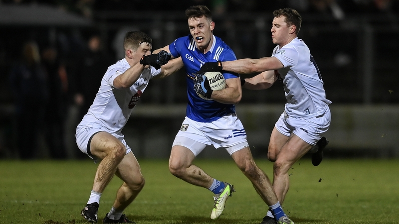 Cavan's Dara McVeety breaks through the challenges of Jack Sargent, left, and Jimmy Hyland