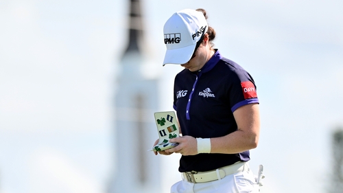 Leona Maguire reads her yardage book on the 18th tee