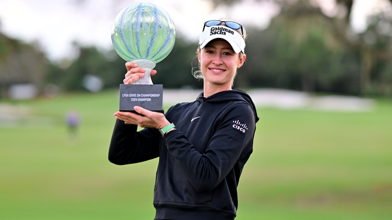 Nelly Korda poses with the trophy after winning at Bradenton Country Club
