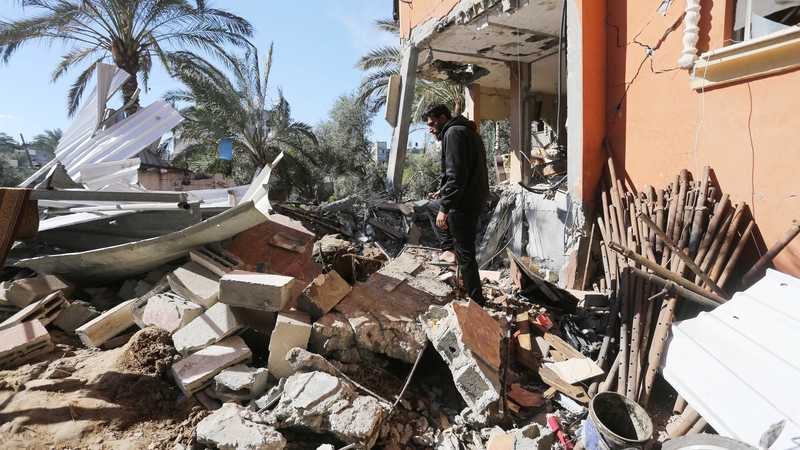 A man inspects the damage after Israeli attacks on a residential building in Deir al-Balah, Gaza