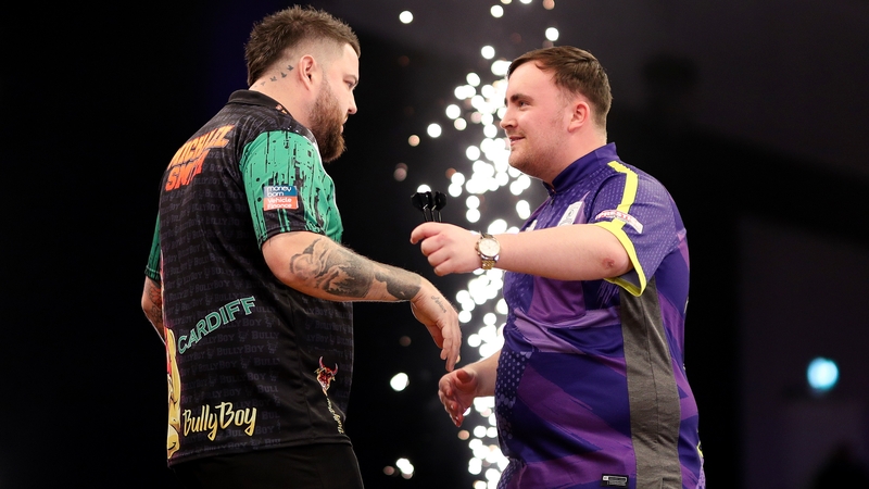 Michael Smith embraces Luke Littler after winning his tussle against the teenage star