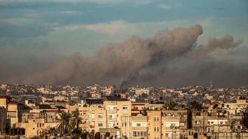A picture taken from Rafah in southern Gaza shows smoke rising over buildings in Khan Younis during Israeli bombardment