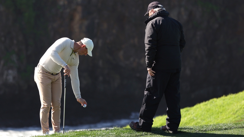 Rory McIlroy taking a drop on the eighth