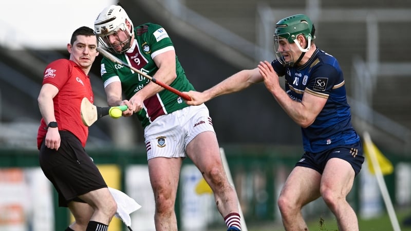 Michael Daly of Westmeath passes under pressure from Gavin Lee