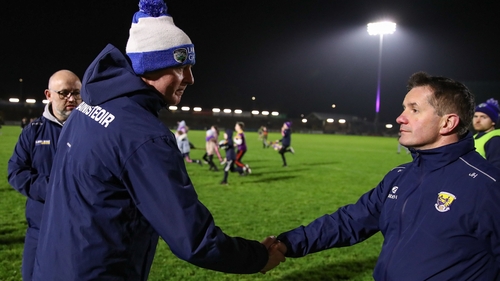 Laois manager Justin McNulty (L) shakes hands with Wexford manager John Hegarty after the game
