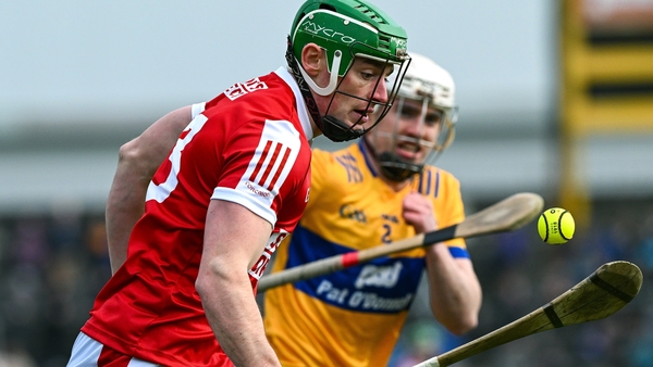 Robbie O Flynn of Cork is tackled by Adam Hogan of Clare