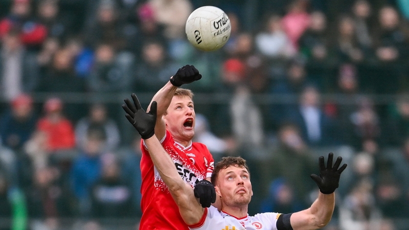 Brendan Rogers gets to the ball ahead of Tyrone's Brian Kennedy