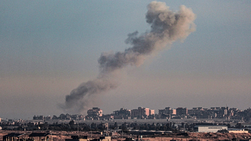 A picture taken from Rafah in southern Gaza shows smoke rising over buildings in Khan Younis today