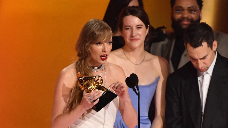 Taylor Swift accepts the Album of the Year Grammy for the fourth time
