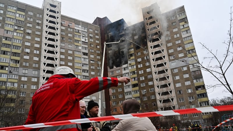 Emergency workers help residents after a missile attack on Kyiv