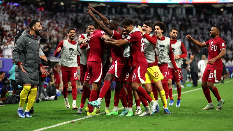 Almoez Ali celebrates scoring Qatar's decisive third goal with his team-mates