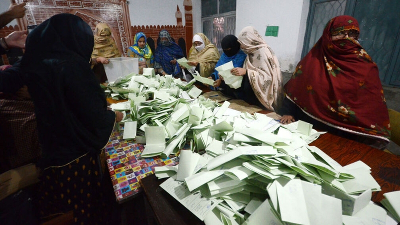 Election officials begin counting votes at a polling station in Peshawar