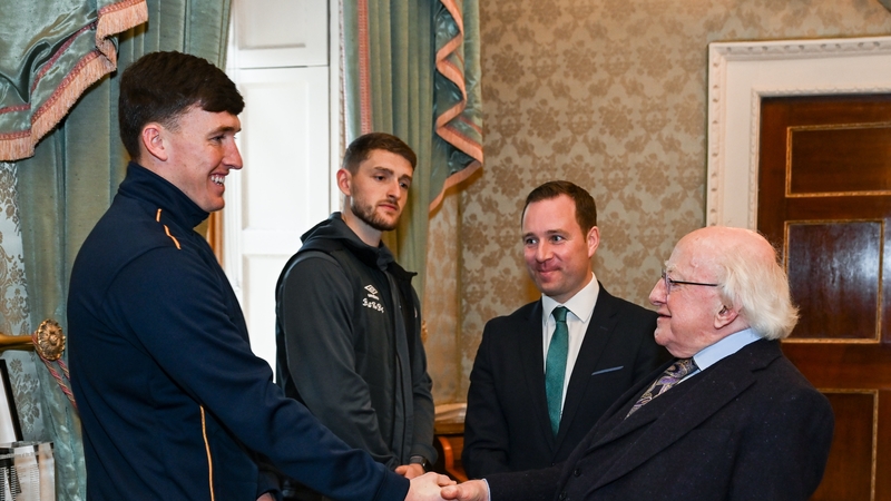 President Michael D Higgins welcomes Joe Redmond of St Patrick's Athletic, left, and Lee Grace of Shamrock Rovers in the company of League of Ireland director Mark Scanlon