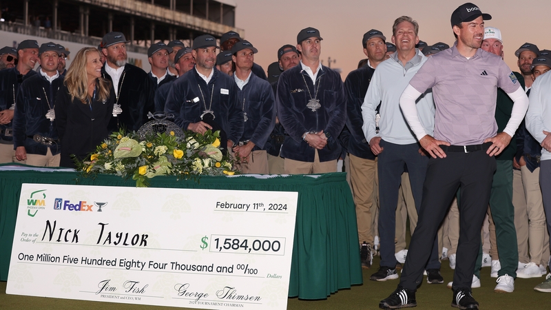 Nick Taylor with his $1.58m winner's cheque at the Phoenix Open