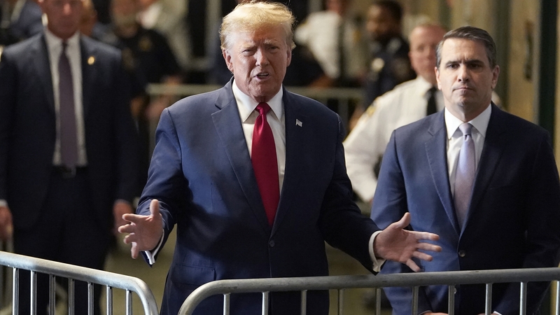Former US president Donald Trump, with his lawyer Todd Blanche, speaks to the press as he arrives at Manhattan Criminal Court