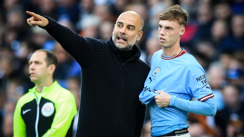 Cole Palmer (R) pictured with his former manager Pep Guardiola last year
