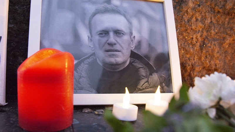 Candles are seen at a vigil for Alexei Navalny outside the Russian embassy in Cologne, Germany