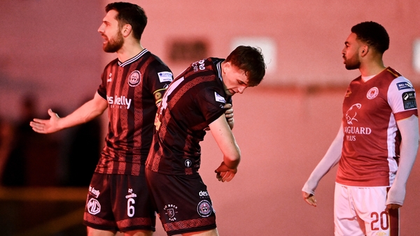 Cian Byrne reacts after being struck on the arm by a flare