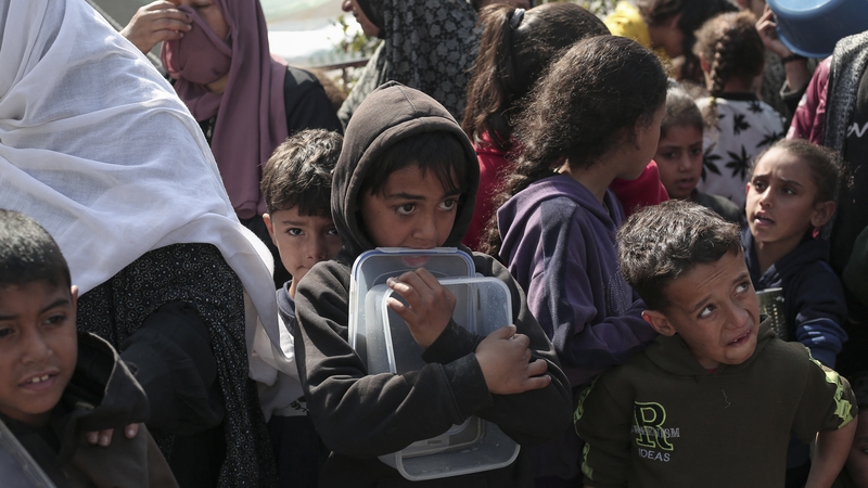Displaced Palestinians gather for food in Rafah