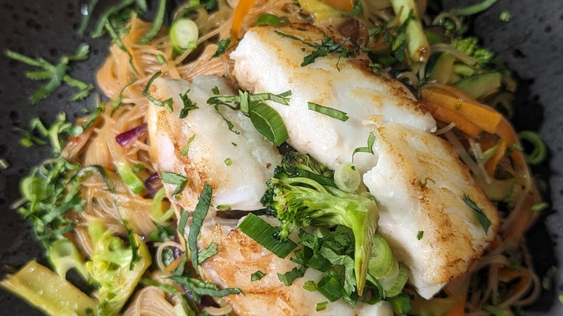 Flakey sea bass is a perfect pairing for these herby and spicy Asian-style noodles.