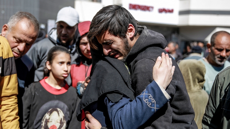 People mourn following an early morning incident when Israeli forces opened fire on crowds rushing at an aid distribution point in Gaza City