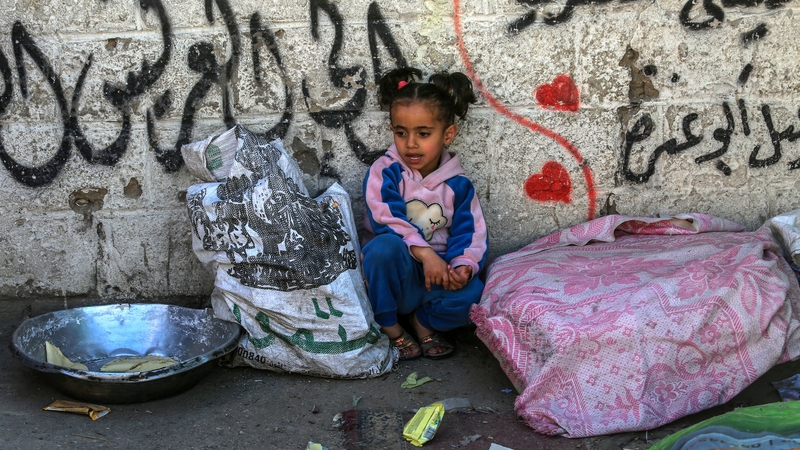 A young girl is seen among those taking refuge in Rafah, where people are living in makeshift tents
