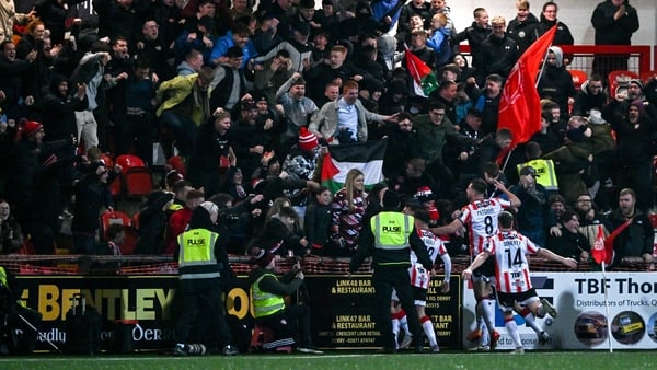 The Derry players celebrate the late winner in front of the home support