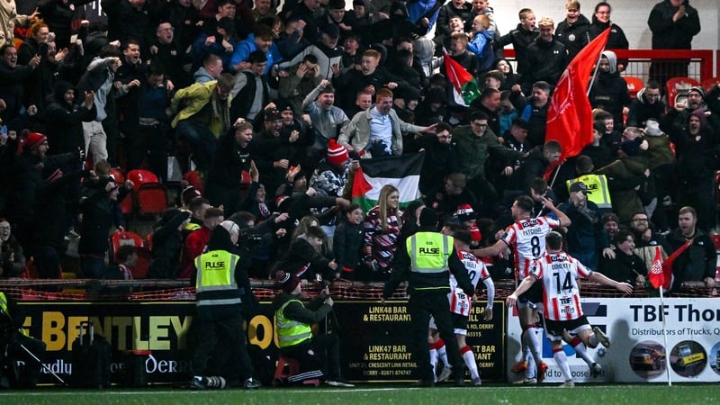 The Derry players celebrate the late winner in front of the home support