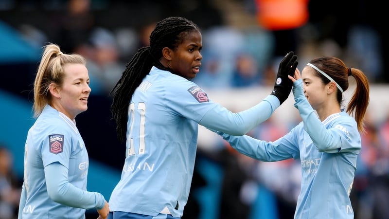 Khadija Shaw (centre) celebrates opening the scoring in Man City's win over Everton