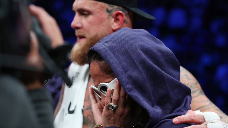 A distraught Amanda Serrano with promoter Jake Paul
