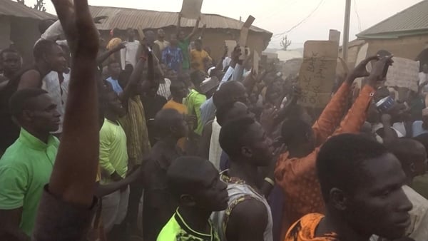 A video grab from AFPTV shows families of abducted pupils gathering during the visit of the Kaduna State governor Uba Sani after gunmen kidnapped over 280 from a school in Kuriga, Nigeria