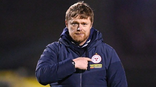Damien Duff points to the Shelbourne crest after his side won at Dalymount Park