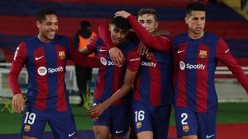 Lamine Yamal is embraced by his Barcelona team-mates