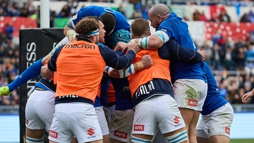 Louis Lynagh is mobbed after his try