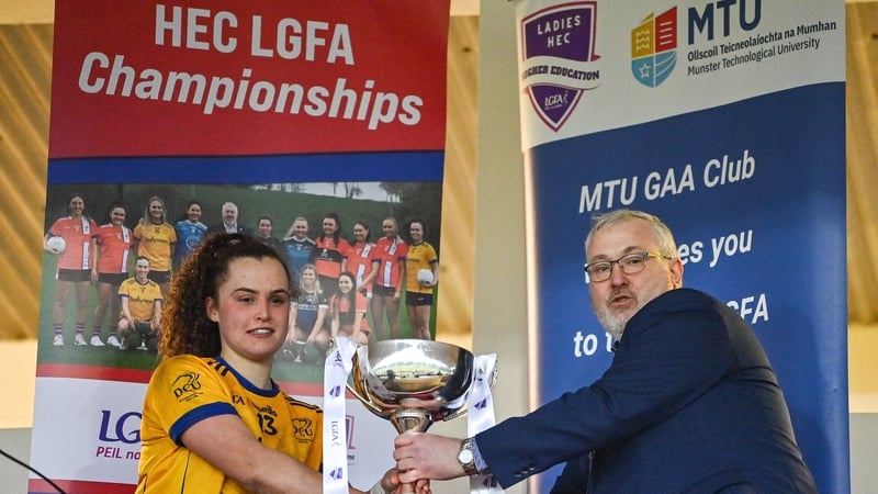 Emma Duggan is presented with the cup by LGFA HEC chairperson Daniel Caldwell