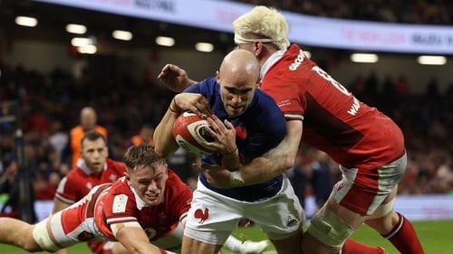Maxime Lucu (C) dives over the line to score France's fifth try
